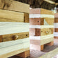 Wooden beehives stacked together with a blurred background